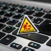 A miniature under construction sign placed on a laptop keyboard symbolizing digital development.